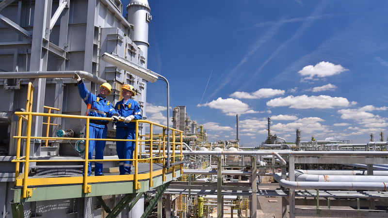 Two industrial workers in a refinery