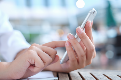 close up woman hand hold use mobile phone device