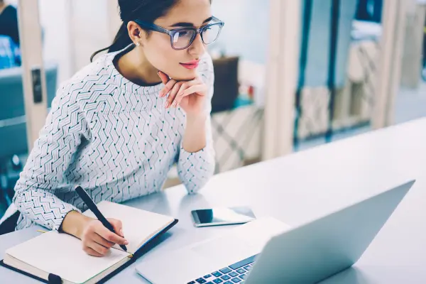 female reading information on laptop