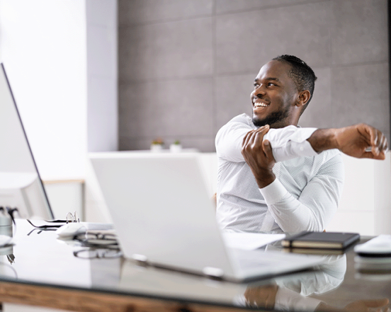 Man Doing Stretch Exercise Workout At Office Business Desk